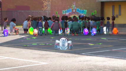 Ron in front of a crowd of people on the playground.