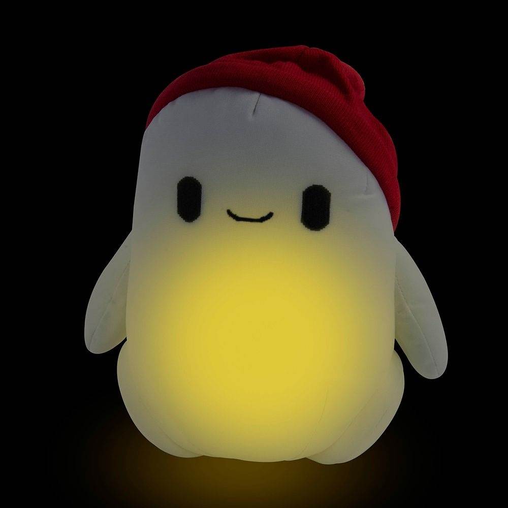 A soft toy of Ron in the dark that is glowing within